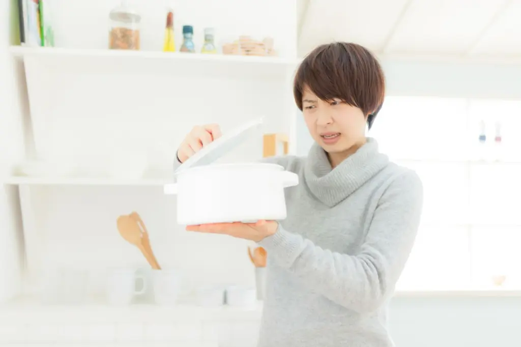 料理中に悩むママの写真